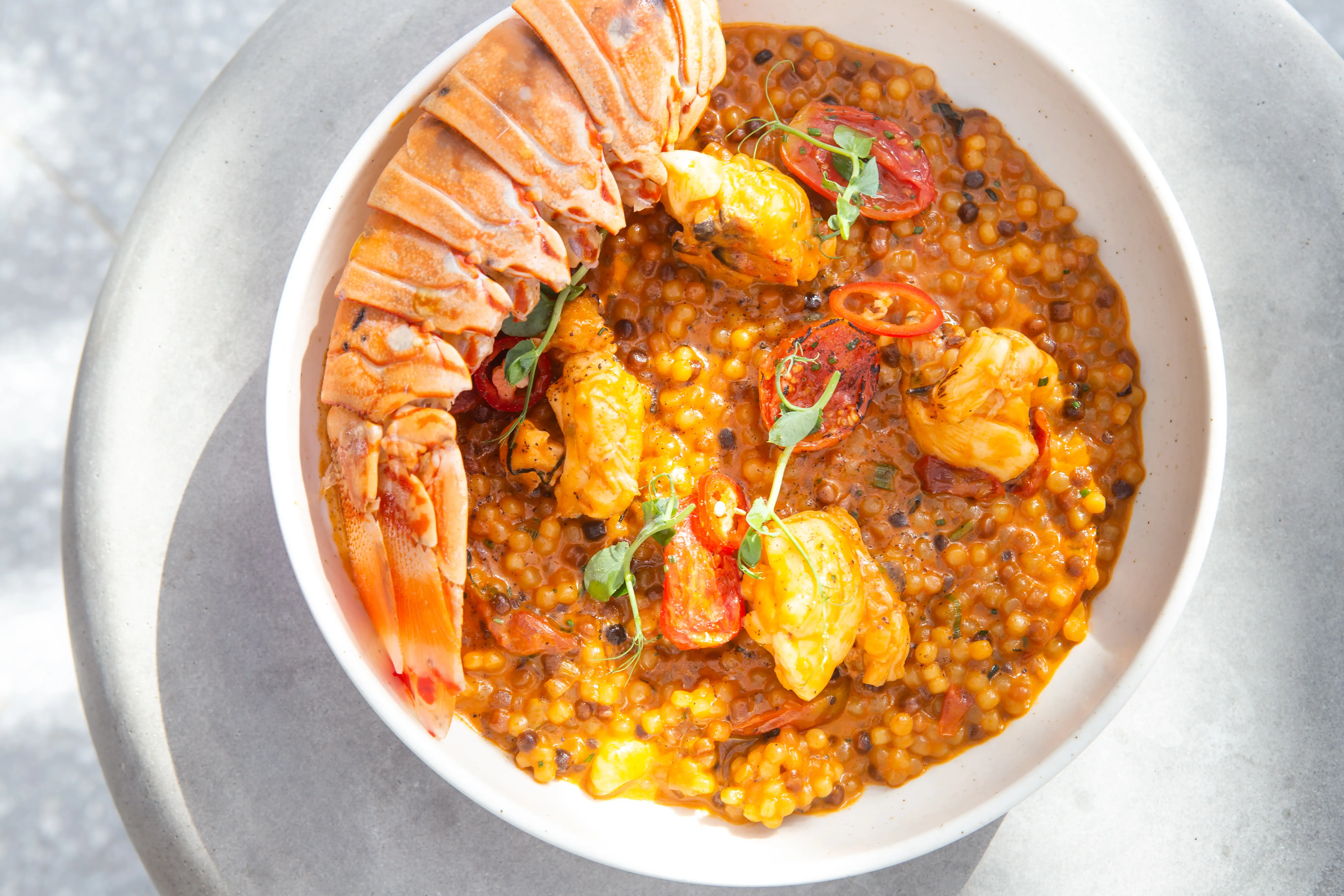 Lobster couscous with shellfish and tomato-chili accents