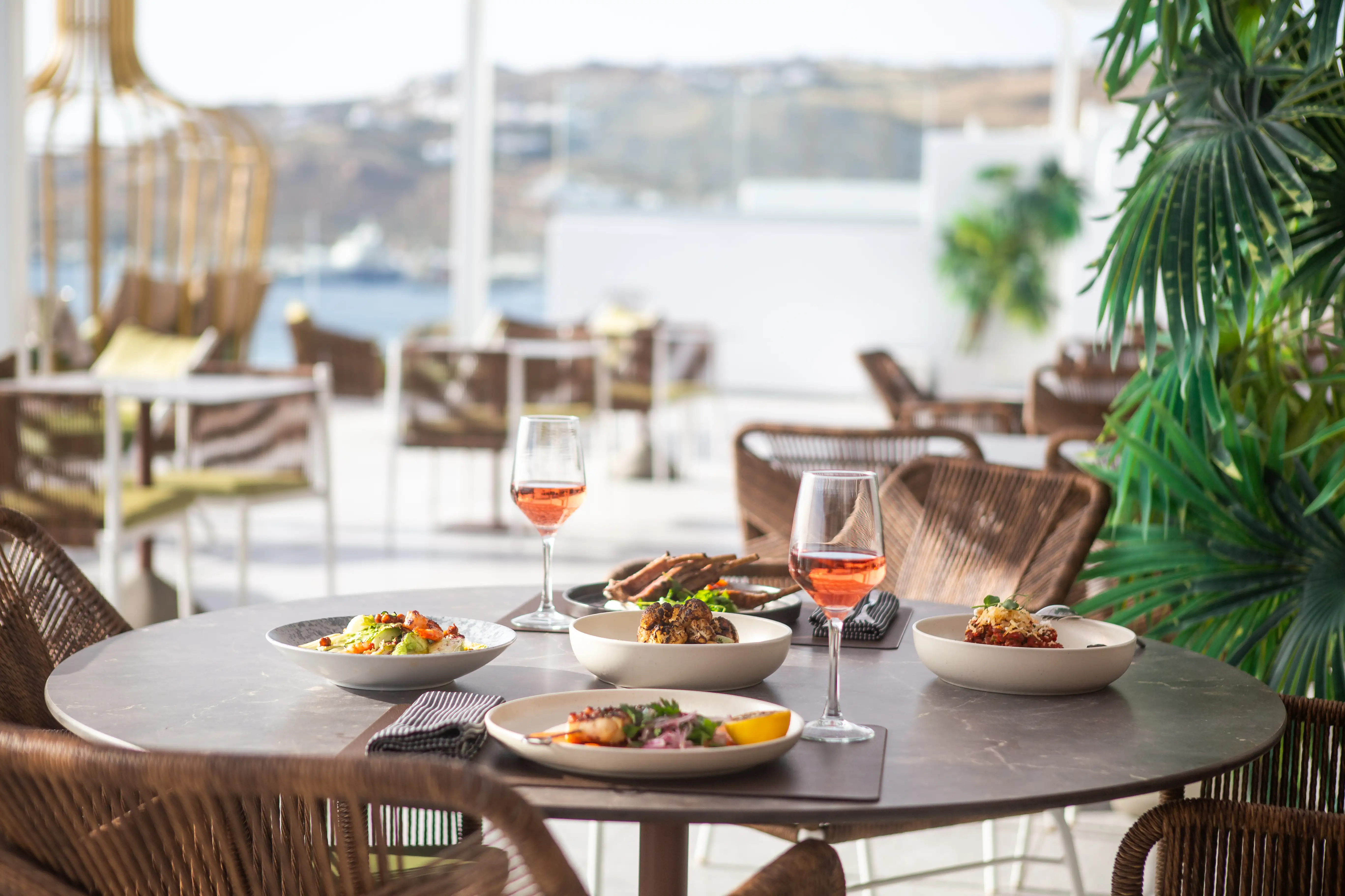 Outdoor dining terrace at Narcissus, Kouros Hotel Mykonos, at twilight